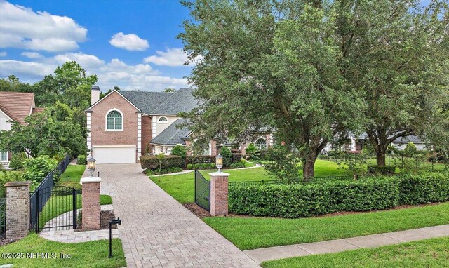 3355 Bishop Estates Rd, Saint Johns, FL 32259 - view of front facade with driveway, a garage, a chimney, a gate, and brick siding