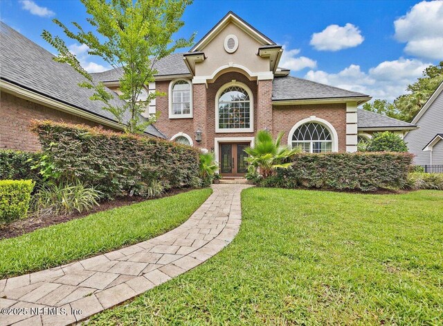 3355 Bishop Estates Rd, Saint Johns, FL 32259 - view of front of house featuring french doors, a front yard, roof with shingles, and brick siding