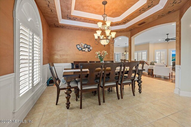 3355 Bishop Estates Rd, Saint Johns, FL 32259 - dining space with a chandelier, arched walkways, a tray ceiling, a ceiling fan, and tile patterned floors