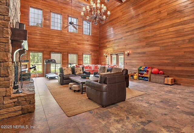 3355 Bishop Estates Rd, Saint Johns, FL 32259 - living room featuring wooden walls, a high ceiling, and a chandelier