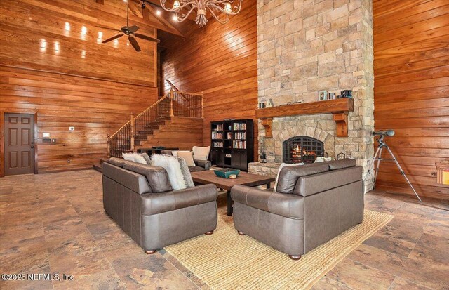 3355 Bishop Estates Rd, Saint Johns, FL 32259 - living area featuring wooden walls, stairs, a chandelier, a high ceiling, and a fireplace