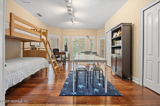 3355 Bishop Estates Rd, Saint Johns, FL 32259 - bedroom featuring wood finished floors, a textured ceiling, and rail lighting