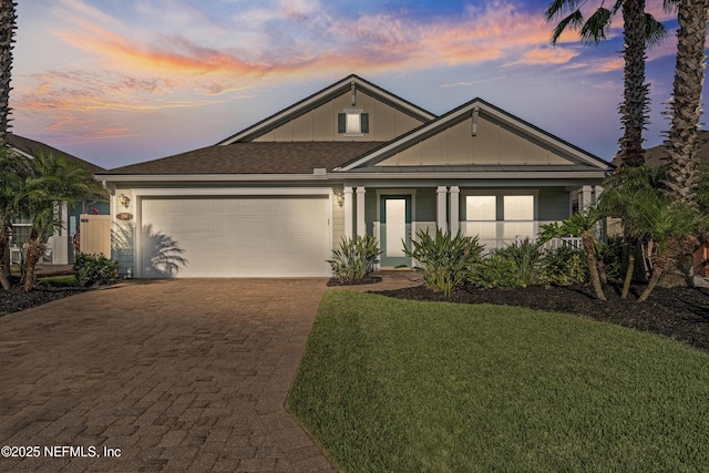 186 Ocean Cay Blvd, Saint Augustine, FL 32080 - view of front of property with decorative driveway, an attached garage, board and batten siding, a front yard, and roof with shingles