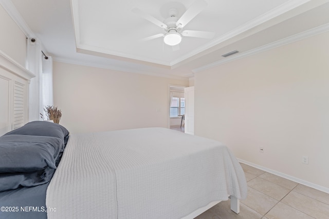 186 Ocean Cay Blvd, Saint Augustine, FL 32080 - bedroom with a tray ceiling, crown molding, light tile patterned floors, a ceiling fan, and baseboards