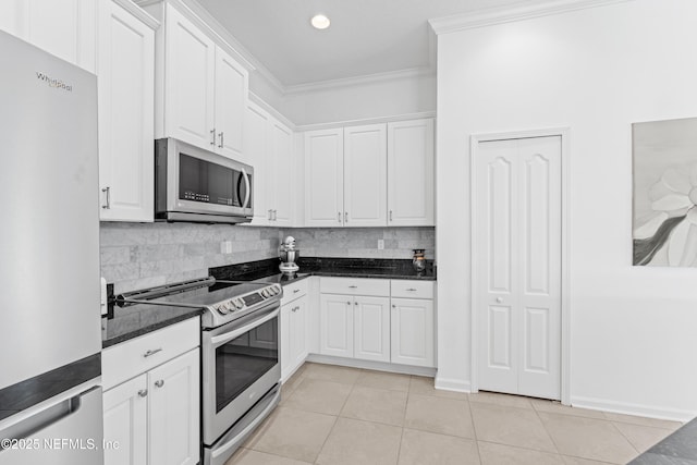 186 Ocean Cay Blvd, Saint Augustine, FL 32080 - kitchen featuring stainless steel appliances, ornamental molding, light tile patterned flooring, white cabinets, and decorative backsplash