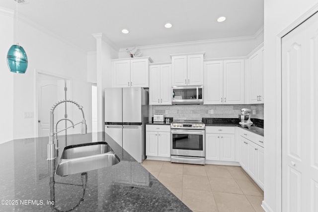 186 Ocean Cay Blvd, Saint Augustine, FL 32080 - kitchen with stainless steel appliances, a sink, crown molding, white cabinets, and light tile patterned flooring