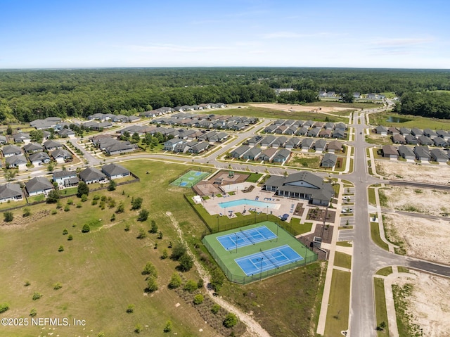 aerial overview of property's location with a forest and nearby suburban area
