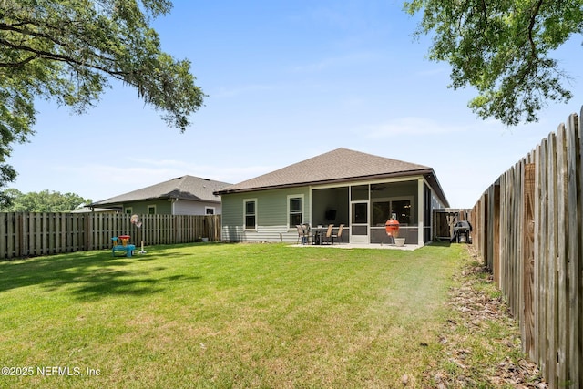 rear view of property featuring ceiling fan, a patio, a sunroom, and roof with shingles