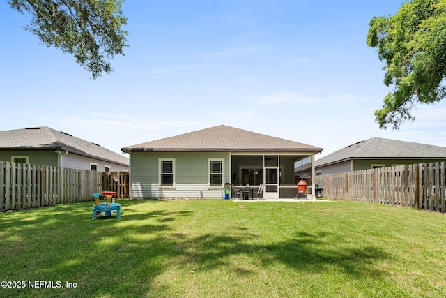 rear view of house featuring a sunroom and roof with shingles