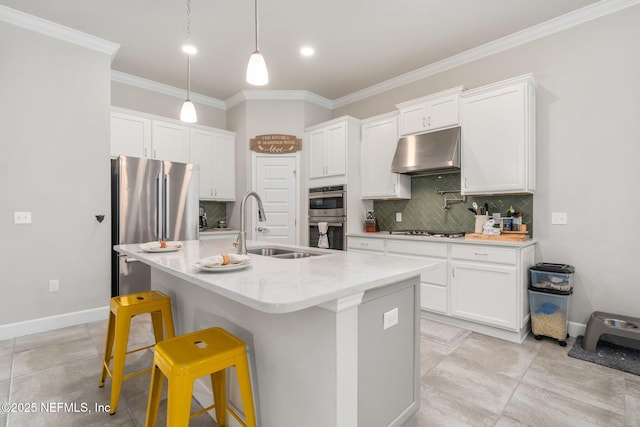 kitchen with under cabinet range hood, appliances with stainless steel finishes, a sink, white cabinets, and ornamental molding