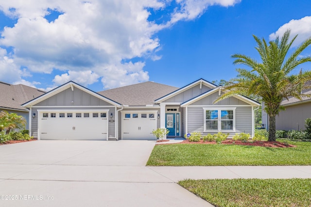 310 Cedarstone Way, Saint Augustine, FL 32092 - view of front of house featuring board and batten siding, an attached garage, concrete driveway, and a front lawn