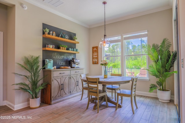 310 Cedarstone Way, Saint Augustine, FL 32092 - dining space with light wood finished floors, healthy amount of natural light, crown molding, and baseboards
