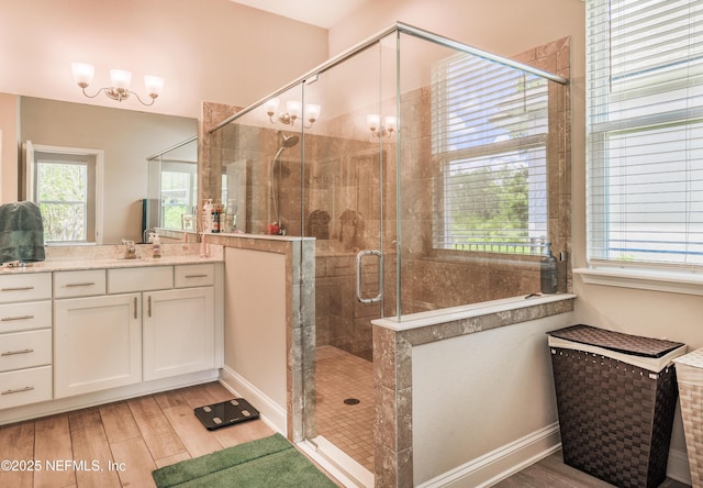 310 Cedarstone Way, Saint Augustine, FL 32092 - full bath with wood finished floors, a shower stall, vanity, and baseboards