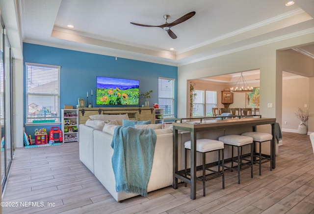 310 Cedarstone Way, Saint Augustine, FL 32092 - living area featuring a raised ceiling, light wood-style floors, a ceiling fan, plenty of natural light, and crown molding
