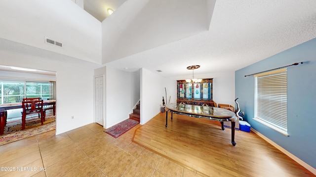 124 Lindsay Dr, Palm Coast, FL 32137 - dining space featuring stairs, light tile patterned floors, and a chandelier