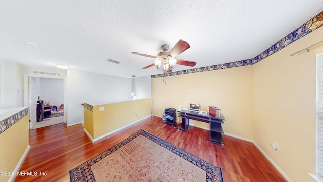 124 Lindsay Dr, Palm Coast, FL 32137 - home office with wood finished floors, ceiling fan, a textured ceiling, and baseboards