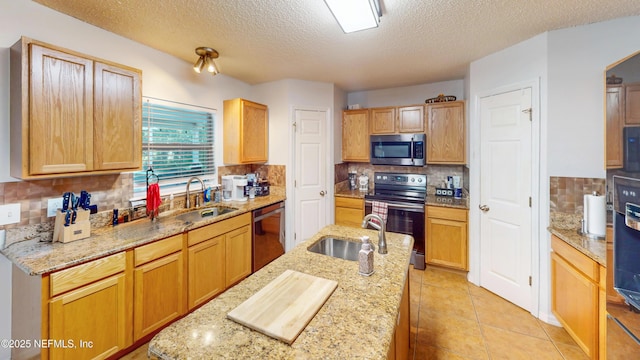 124 Lindsay Dr, Palm Coast, FL 32137 - kitchen with stainless steel appliances, a sink, tasteful backsplash, a textured ceiling, and light stone counters