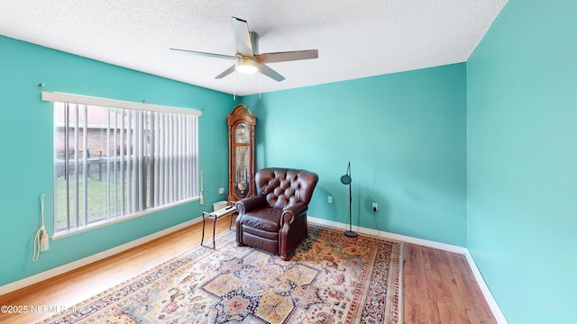 124 Lindsay Dr, Palm Coast, FL 32137 - living area featuring ceiling fan, wood finished floors, a textured ceiling, and baseboards