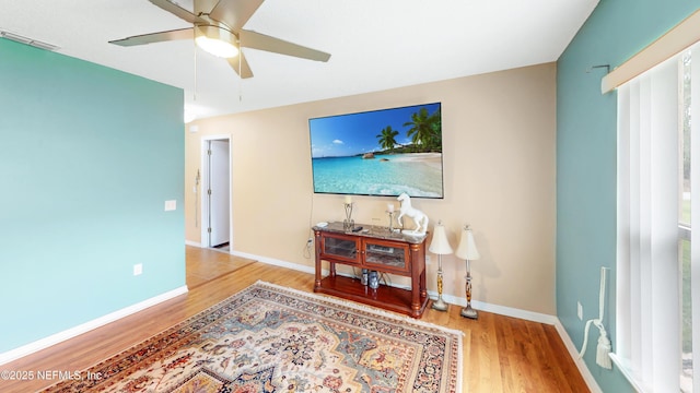 124 Lindsay Dr, Palm Coast, FL 32137 - living area with wood finished floors, ceiling fan, and baseboards