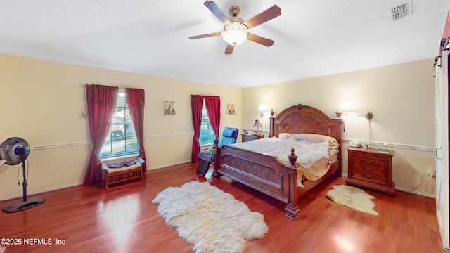 124 Lindsay Dr, Palm Coast, FL 32137 - bedroom featuring wood finished floors, ceiling fan, a textured ceiling, and baseboards