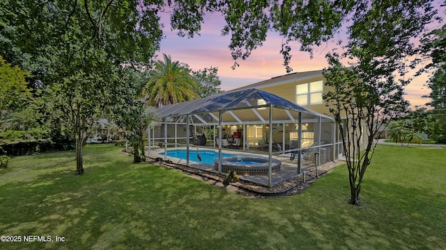 124 Lindsay Dr, Palm Coast, FL 32137 - view of pool featuring a lawn, a patio area, glass enclosure, and a pool with connected hot tub