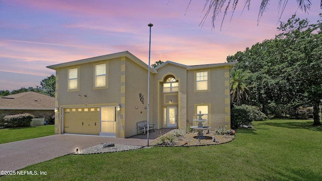 124 Lindsay Dr, Palm Coast, FL 32137 - view of front of house with stucco siding, a garage, a yard, and concrete driveway