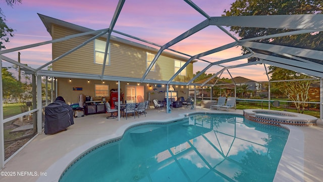 124 Lindsay Dr, Palm Coast, FL 32137 - pool at dusk featuring a patio, glass enclosure, grilling area, and a pool with connected hot tub