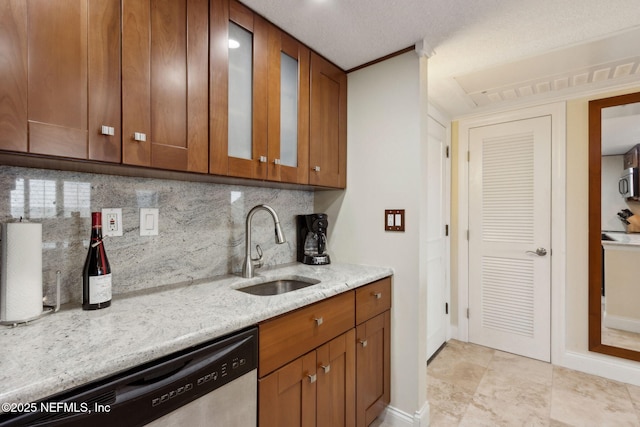 278 Sandcastles Ct, Fernandina Beach, FL 32034 - kitchen with stainless steel appliances, a sink, light stone counters, decorative backsplash, and brown cabinets