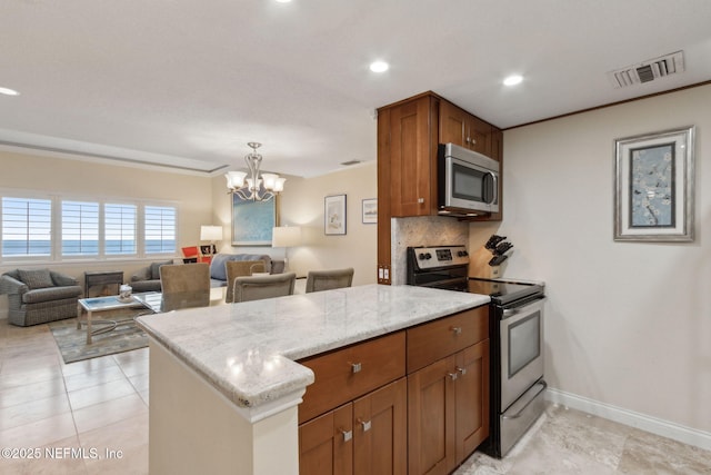 278 Sandcastles Ct, Fernandina Beach, FL 32034 - kitchen with appliances with stainless steel finishes, a peninsula, brown cabinets, a chandelier, and tasteful backsplash