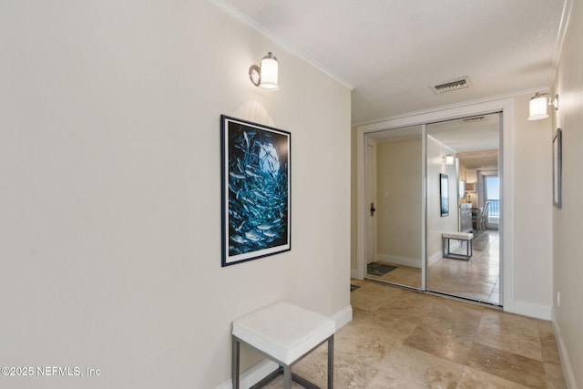 278 Sandcastles Ct, Fernandina Beach, FL 32034 - corridor featuring ornamental molding, baseboards, and light stone finish flooring