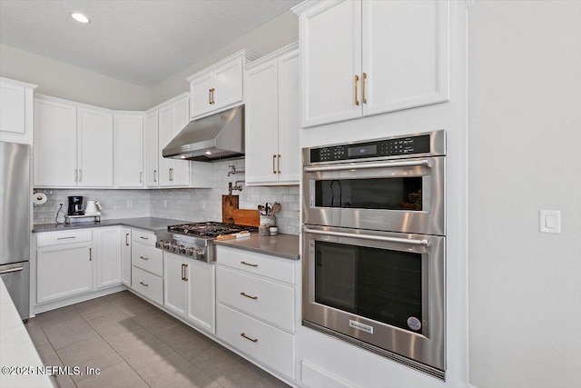 45 Waterwheel Ct, Saint Johns, FL 32259 - kitchen featuring under cabinet range hood, stainless steel appliances, tasteful backsplash, white cabinets, and recessed lighting