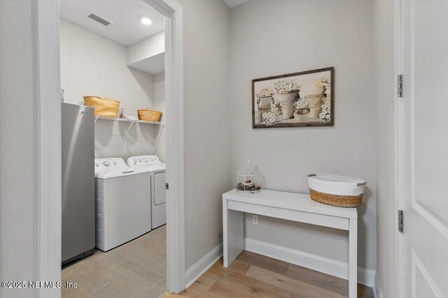 45 Waterwheel Ct, Saint Johns, FL 32259 - washroom with washing machine and dryer, light wood-style flooring, and baseboards