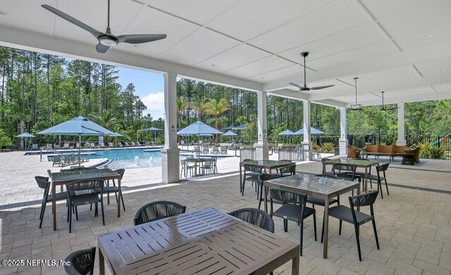 45 Waterwheel Ct, Saint Johns, FL 32259 - view of patio / terrace with outdoor dining space, a ceiling fan, a community pool, an outdoor living space, and view of wooded area