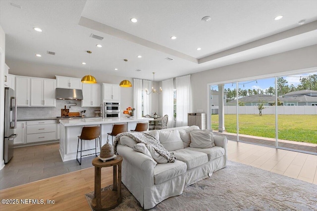 45 Waterwheel Ct, Saint Johns, FL 32259 - living room with recessed lighting, light wood-style floors, and a chandelier