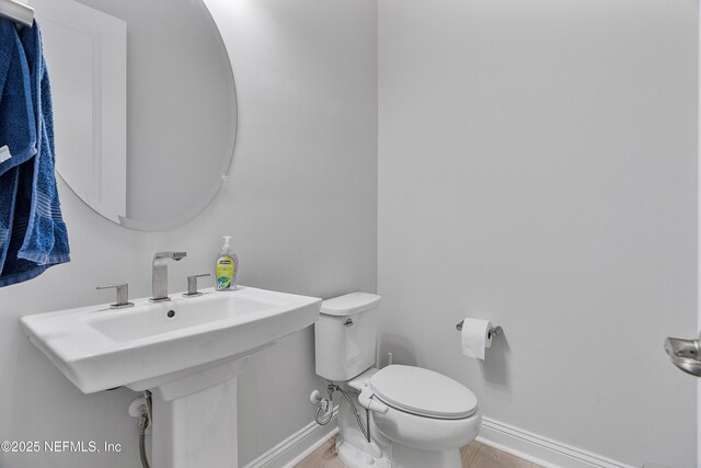 144 Waverly Way, Saint Johns, FL 32259 - bathroom with baseboards, toilet, and wood finished floors
