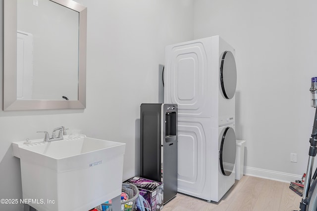 144 Waverly Way, Saint Johns, FL 32259 - washroom featuring stacked washer / drying machine, light wood-style floors, and baseboards
