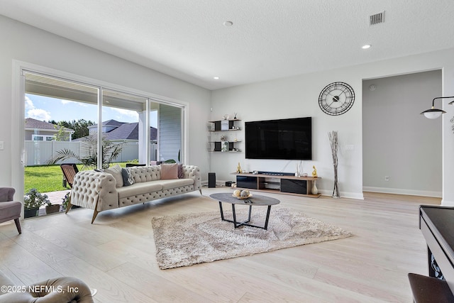 144 Waverly Way, Saint Johns, FL 32259 - living area with wood finished floors, a textured ceiling, recessed lighting, and baseboards