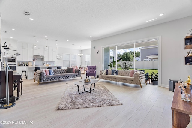 144 Waverly Way, Saint Johns, FL 32259 - living room with a chandelier, light wood-type flooring, recessed lighting, and a textured ceiling