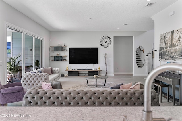 144 Waverly Way, Saint Johns, FL 32259 - living area featuring wood finished floors, plenty of natural light, recessed lighting, baseboards, and a textured ceiling