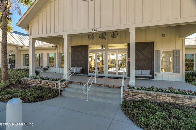 144 Waverly Way, Saint Johns, FL 32259 - entrance to property with covered porch, french doors, and board and batten siding