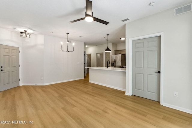 2330 Golden Lake Loop, Saint Augustine, FL 32084 - unfurnished living room with ceiling fan, light wood-style floors, a chandelier, and baseboards