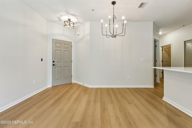 2330 Golden Lake Loop, Saint Augustine, FL 32084 - unfurnished dining area featuring a chandelier, light wood-style flooring, and baseboards