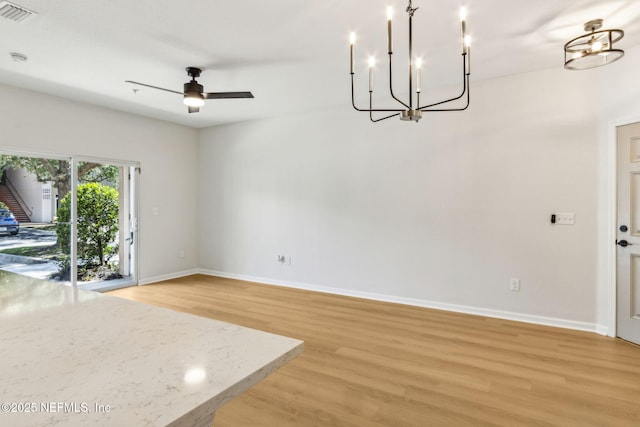 2330 Golden Lake Loop, Saint Augustine, FL 32084 - unfurnished living room featuring a chandelier, light wood-style floors, baseboards, and a ceiling fan