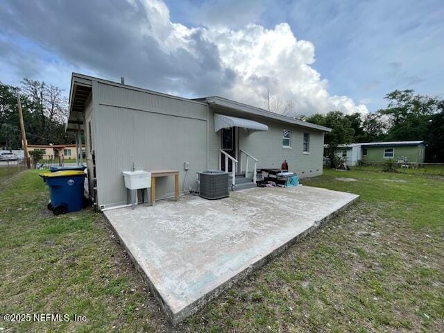 10566 Arendal Rd, Jacksonville, FL 32218 - rear view of house with a patio area, a yard, central AC, and entry steps