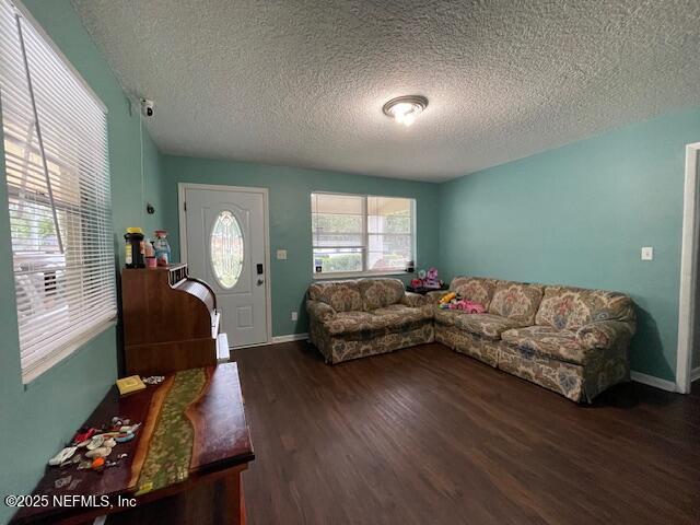 10566 Arendal Rd, Jacksonville, FL 32218 - living area with a textured ceiling, wood finished floors, and baseboards