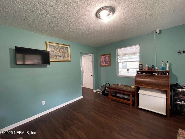 10566 Arendal Rd, Jacksonville, FL 32218 - sitting room with a textured ceiling, wood finished floors, and baseboards