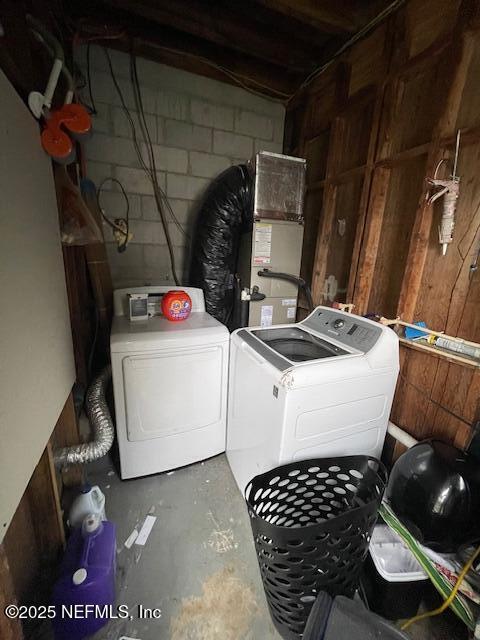 10566 Arendal Rd, Jacksonville, FL 32218 - washroom featuring washer and clothes dryer, concrete block wall, heating unit, and wooden walls