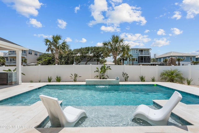 view of swimming pool featuring a fenced backyard and a residential view