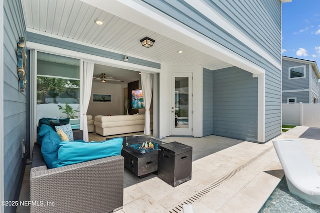 view of patio / terrace with a fire pit and fence