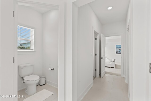 bathroom with toilet, baseboards, ensuite bathroom, and recessed lighting